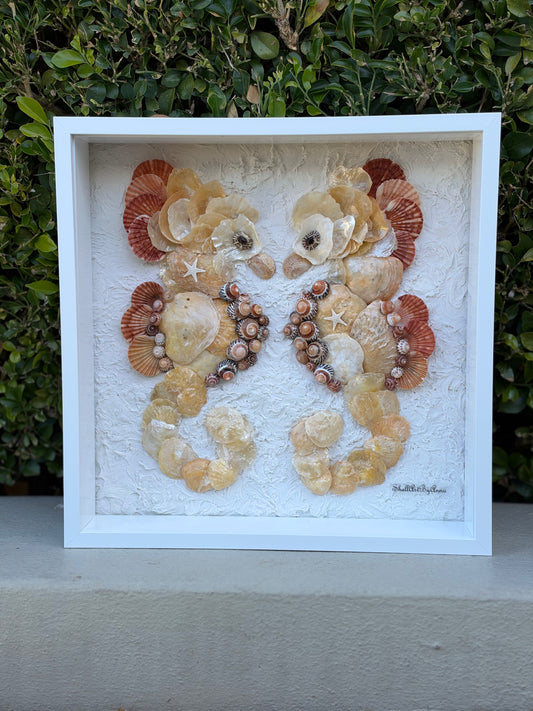 Seashell seahorse pair with small starfish against a textured white background