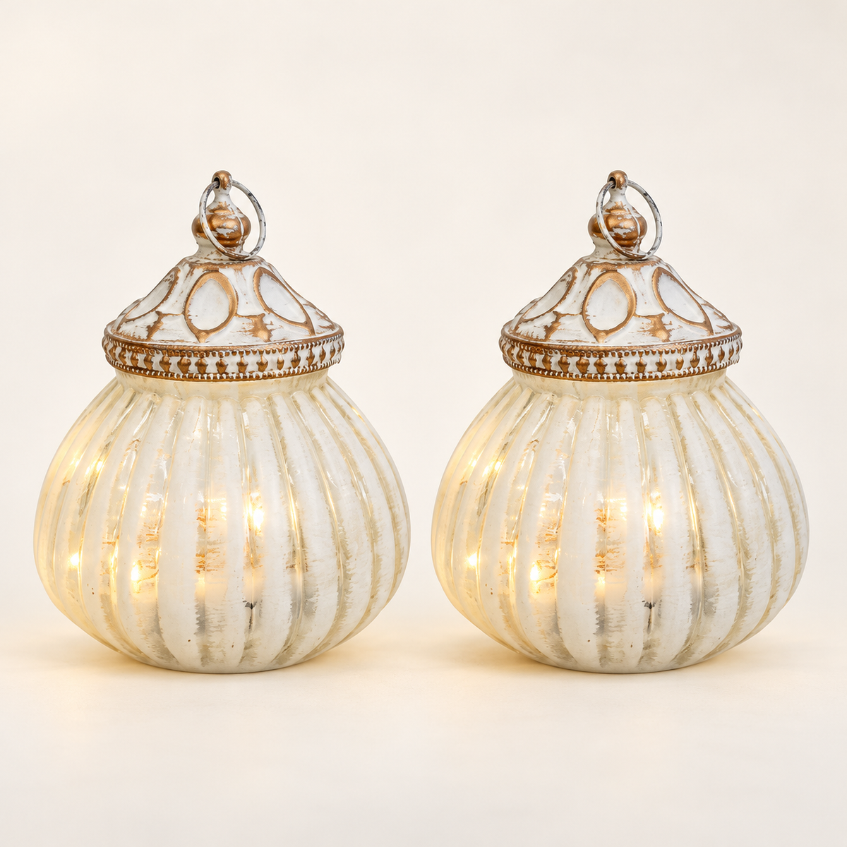 Product mockup showing two matching Balle White LED Lanterns with antique gold caps