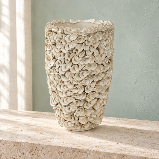 Tidal sculptural stoneware vase styled on limestone against a soft seafoam coastal backdrop