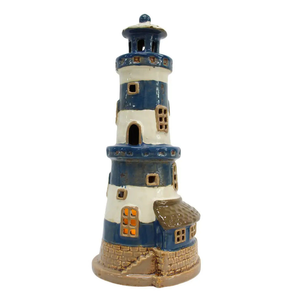 Beacon Cove Lighthouse in blue and cream with cut-out windows and a stone-effect base, shown in full on a white background.