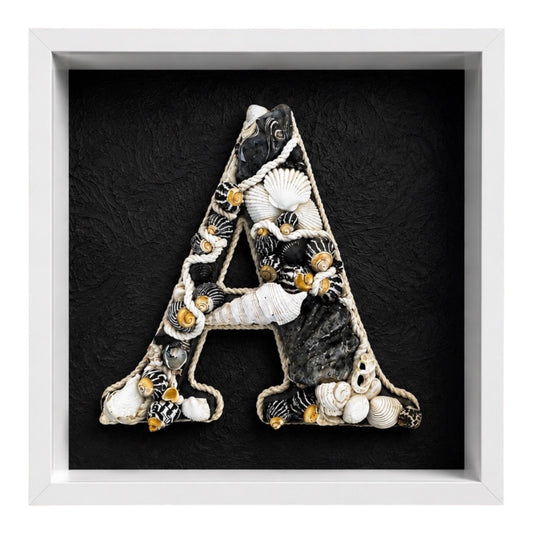 Handmade framed shell art initial created with rope, black and white coloured natural seashells in a white shadow box frame, a personalised coastal keepsake for nursery or bedroom decor.
Available in all letters and made to order.