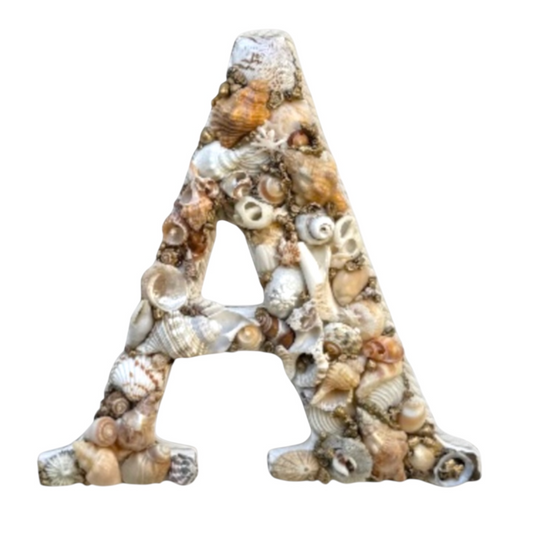 Handmade shell art initial in white, beige, cream and gold tones, a personalised coastal keepsake gift for a nursery, bedroom or door sign. Available in all letters.